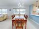 Dining room with hardwood table and chairs, and water views at 325 Causeway # E 203, New Smyrna Beach, FL 32169