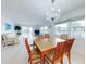 Spacious dining area with wood table and chairs near living room at 325 Causeway # E 203, New Smyrna Beach, FL 32169