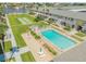 Community pool and shuffleboard in aerial view at 335 N Causeway # H050, New Smyrna Beach, FL 32169