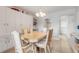 Dining room features built-in cabinetry and light wood table at 335 N Causeway # H050, New Smyrna Beach, FL 32169