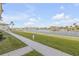 Scenic waterfront view with lush green grass and walkway at 335 N Causeway # H050, New Smyrna Beach, FL 32169