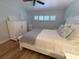 Bedroom with queen bed, white dresser, and light blue walls at 335 N Causeway # H23, New Smyrna Beach, FL 32169