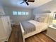 Bedroom with queen bed, white dresser, and light blue walls at 335 N Causeway # H23, New Smyrna Beach, FL 32169