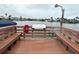 Community boat dock with benches, a fire extinguisher, and water access at 335 N Causeway # H23, New Smyrna Beach, FL 32169