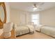 Bright bedroom with twin beds, nightstands, and ceiling fan at 3441 Gaveson Ct, Port Orange, FL 32129