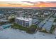 Aerial view of beachfront community with pool and tennis courts at 401 N Atlantic Ave # 504, New Smyrna Beach, FL 32169