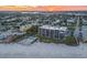 Aerial view of beachfront building with pool and parking at 401 N Atlantic Ave # 504, New Smyrna Beach, FL 32169