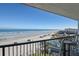 Stunning ocean view from balcony, featuring beach, cars, and pool at 401 N Atlantic Ave # 504, New Smyrna Beach, FL 32169