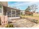 Screened porch, patio, and playset in a fenced backyard at 413 Division Ave, Ormond Beach, FL 32174