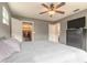 Main bedroom with ceiling fan, dresser, and large closet at 413 Division Ave, Ormond Beach, FL 32174