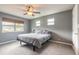 Spacious bedroom with ceiling fan, large windows, and plush carpeting at 413 Division Ave, Ormond Beach, FL 32174