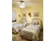 Guest bedroom with two twin beds and coastal-themed decor at 4141 S Atlantic Ave # 602, New Smyrna Beach, FL 32169