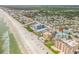 Aerial view showcasing a teal building's location near the beach and other buildings at 423 S Atlantic Ave # 101, New Smyrna Beach, FL 32169