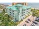 Aerial view showcasing a teal building's rear and parking area at 423 S Atlantic Ave # 101, New Smyrna Beach, FL 32169