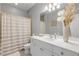 Bathroom with white vanity, shower, and neutral decor at 423 S Atlantic Ave # 101, New Smyrna Beach, FL 32169