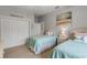 Bedroom with twin beds, closet, and beach-themed decor at 423 S Atlantic Ave # 101, New Smyrna Beach, FL 32169