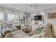 L-shaped sofa faces the ocean in this living room at 423 S Atlantic Ave # 101, New Smyrna Beach, FL 32169