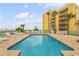 Community pool with lounge chairs and ocean view at 423 S Atlantic Ave # 101, New Smyrna Beach, FL 32169