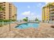 Community pool with lounge chairs and ocean view at 423 S Atlantic Ave # 101, New Smyrna Beach, FL 32169