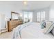 Bright bedroom with king-size bed, dresser, and balcony access at 434 Bouchelle Dr # 202, New Smyrna Beach, FL 32169