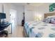 Bright bedroom with king-size bed, workspace, and access to a second room at 434 Bouchelle Dr # 202, New Smyrna Beach, FL 32169