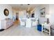 Bright dining room features a glass table with white chairs and hardwood floors at 434 Bouchelle Dr # 202, New Smyrna Beach, FL 32169