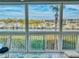 Enclosed balcony showcasing scenic waterfront views and marina at 434 Bouchelle Dr # 202, New Smyrna Beach, FL 32169