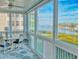 Relaxing screened porch with water views and seating area at 434 Bouchelle Dr # 202, New Smyrna Beach, FL 32169