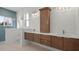 Modern bathroom with double vanity, wood cabinets, and a walk-in shower at 437 S Peninsula Ave, New Smyrna Beach, FL 32169