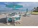 Beachfront patio furniture with umbrellas and ocean view at 4501 S Atlantic Ave # 5180, New Smyrna Beach, FL 32169