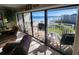 Living room with sliding doors opening to a stunning ocean view at 4501 S Atlantic Ave # 5180, New Smyrna Beach, FL 32169