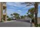 Gated parking area with palm trees and building view at 4501 S Atlantic Ave # 5180, New Smyrna Beach, FL 32169