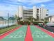 Shuffleboard courts with ocean view and building in background at 4501 S Atlantic Ave # 5180, New Smyrna Beach, FL 32169