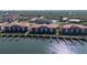 Aerial view of waterfront condos, marina docks, and lush green surroundings at 456 Bouchelle Dr # 202, New Smyrna Beach, FL 32169