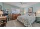 Serene bedroom with soft lighting, dresser, ceiling fan and a comfortable bed at 456 Bouchelle Dr # 202, New Smyrna Beach, FL 32169