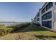 Beautiful waterfront condominium featuring screened lanais, landscaping, and serene water views at 456 Bouchelle Dr # 202, New Smyrna Beach, FL 32169