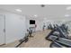 Bright gym area with modern equipment, featuring treadmills, rowing machines, and mirrored wall at 456 Bouchelle Dr # 202, New Smyrna Beach, FL 32169