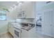 Bright kitchen area featuring granite countertops, white cabinetry, and modern appliances at 456 Bouchelle Dr # 202, New Smyrna Beach, FL 32169