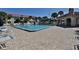 Community pool with lounge chairs and sun umbrellas for relaxation at 456 Bouchelle Dr # 202, New Smyrna Beach, FL 32169