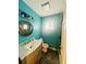 Clean bathroom with teal walls, marble vanity, and shower at 472 Wildwood Dr, New Smyrna Beach, FL 32168