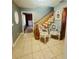 Inviting entryway with tiled floors and a staircase leading upstairs at 472 Wildwood Dr, New Smyrna Beach, FL 32168