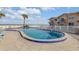 Relaxing kidney-shaped pool with ocean views and lounge chairs at 505 N Atlantic Ave # 29, New Smyrna Beach, FL 32169