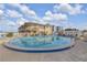 Refreshing kidney-shaped pool with building reflection and lounge chairs at 505 N Atlantic Ave # 29, New Smyrna Beach, FL 32169