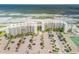 Aerial showcasing beachfront property with ample parking and tennis court at 5203 S Atlantic Ave # 412B, New Smyrna Beach, FL 32169