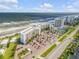 Aerial view showcasing condo building, parking, and oceanfront location at 5203 S Atlantic Ave # 412B, New Smyrna Beach, FL 32169