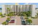 Aerial view of beachfront condo building with parking and palm trees at 5203 S Atlantic Ave # 412B, New Smyrna Beach, FL 32169