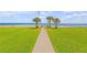 Pathway to the beach with lush green lawn at 5203 S Atlantic Ave # 412B, New Smyrna Beach, FL 32169