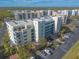 Aerial view of building showcasing parking and landscaping at 5300 S Atlantic Ave # 15-401, New Smyrna Beach, FL 32169