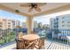 Private balcony with table and chairs, offering scenic views of the surrounding area at 5300 S Atlantic Ave # 15-401, New Smyrna Beach, FL 32169