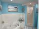 This blue bathroom has a jetted tub and a glass-enclosed shower at 5300 S Atlantic Ave # 5-206, New Smyrna Beach, FL 32169